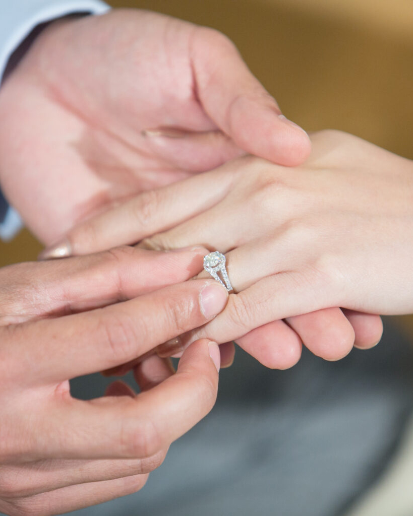 Thai groom putting a wedding ring